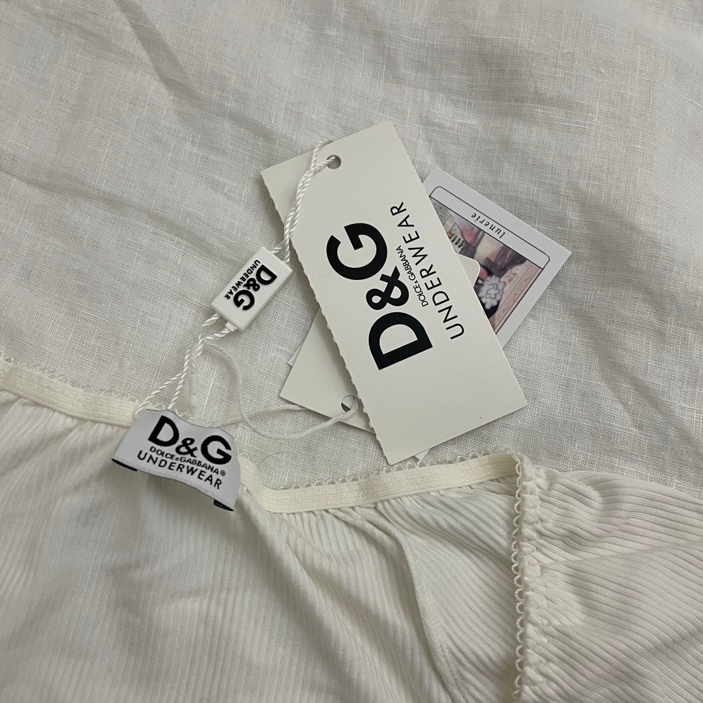 d&g white puff sleeve ribbed shirt with grey italic text and cute bow charms