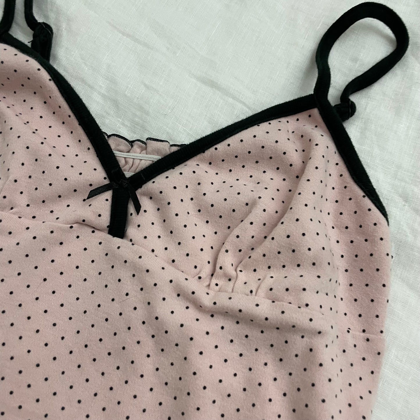 coquette preppy baby pink polka dot camisole with black straps and lettuce trim hem