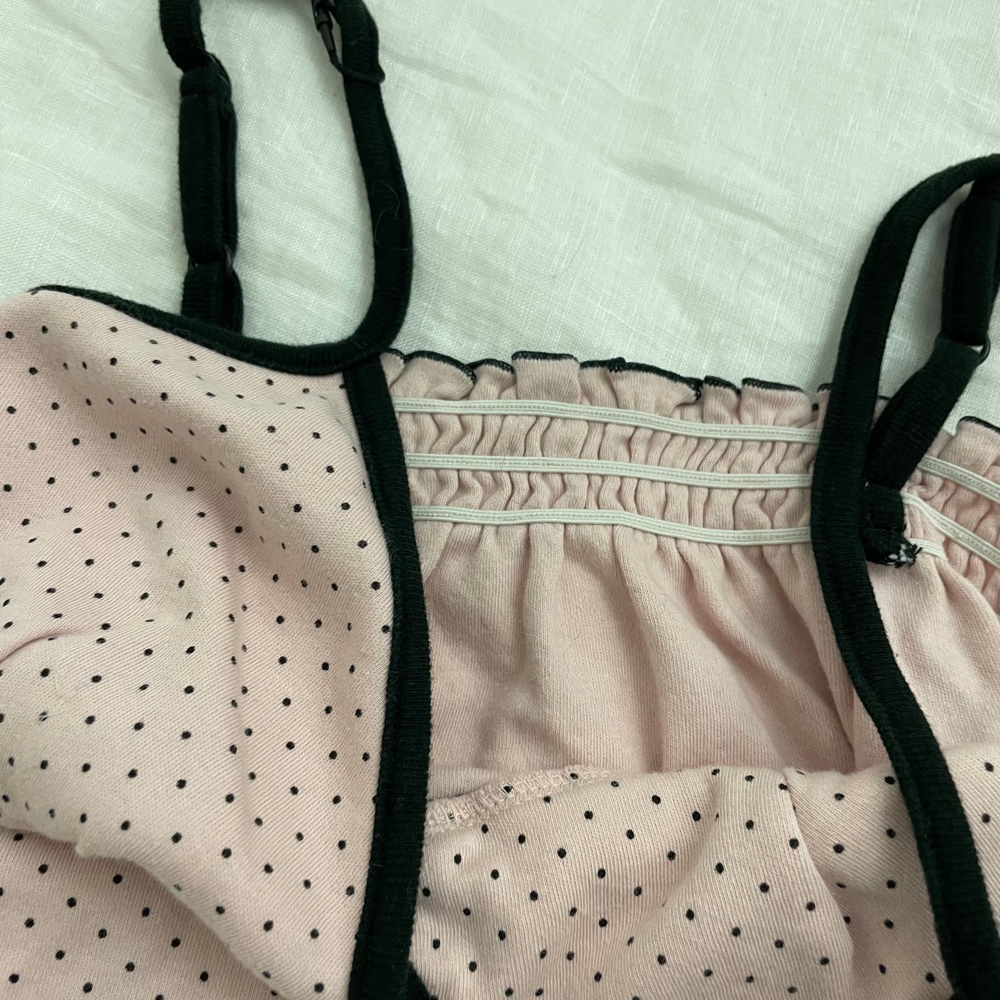 coquette preppy baby pink polka dot camisole with black straps and lettuce trim hem