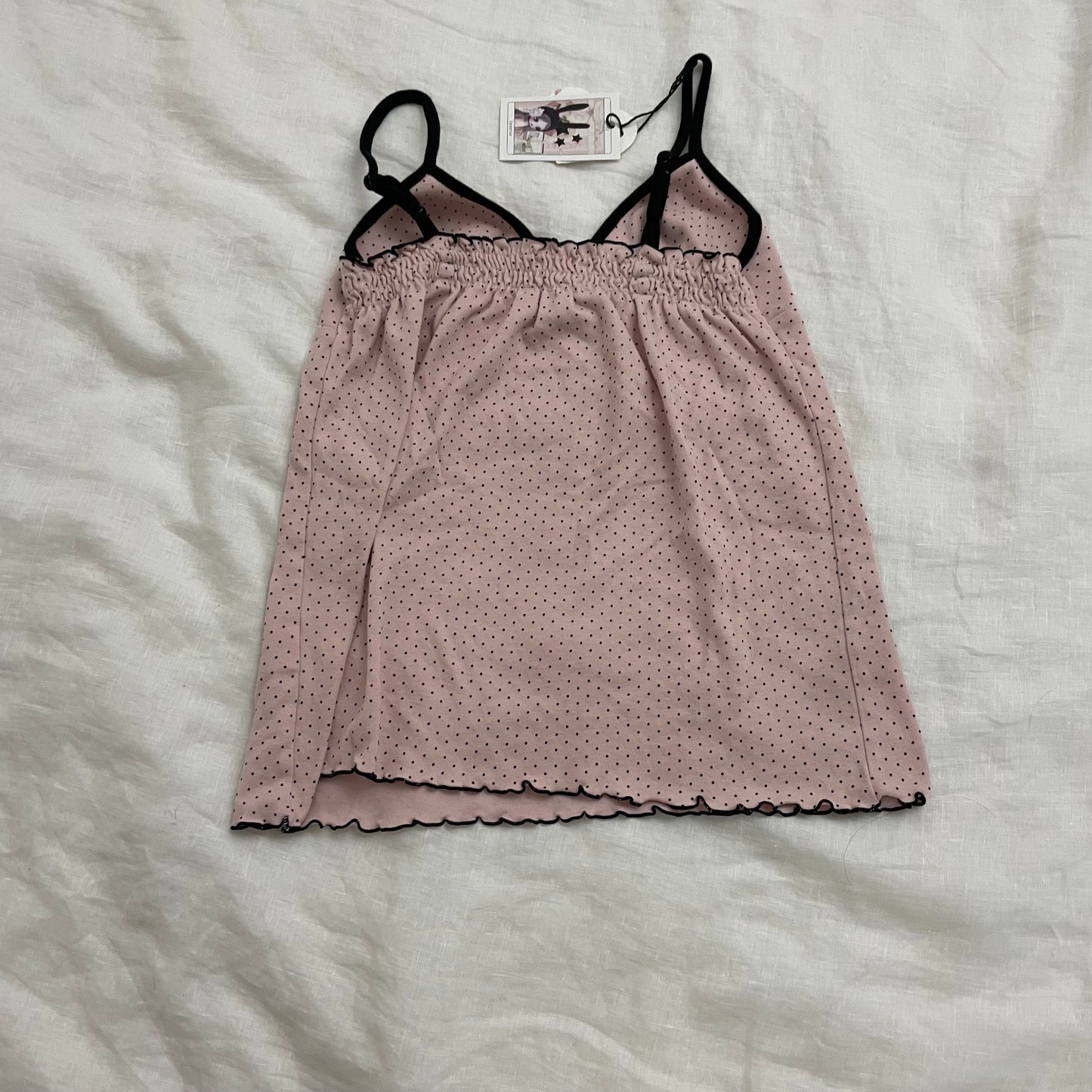 coquette preppy baby pink polka dot camisole with black straps and lettuce trim hem