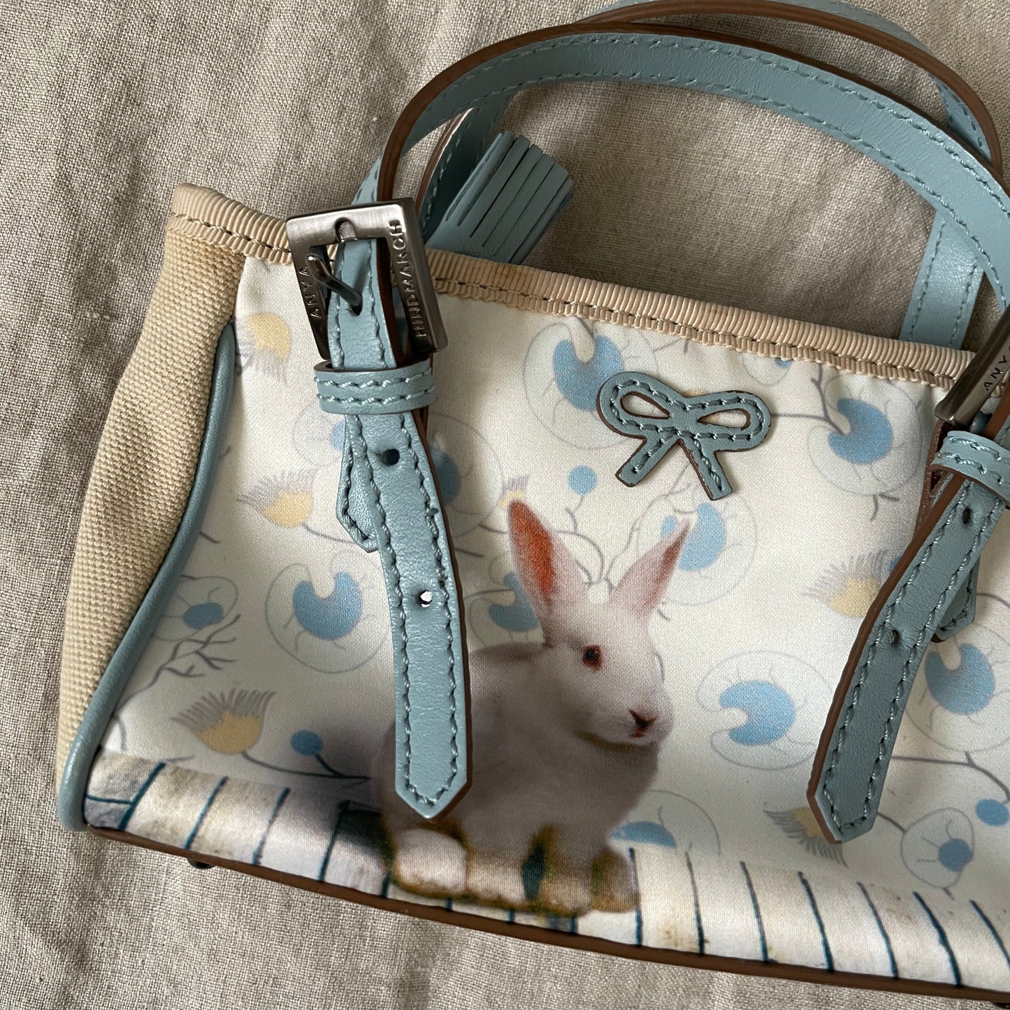 coquette anya hindmarch baby blue x beige rabbit print shoulder bag with bow leather detail