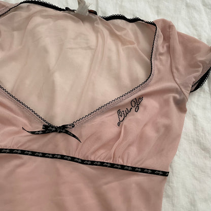 light pink liu jo cap sleeve sheer top with black picot trim and bow charm