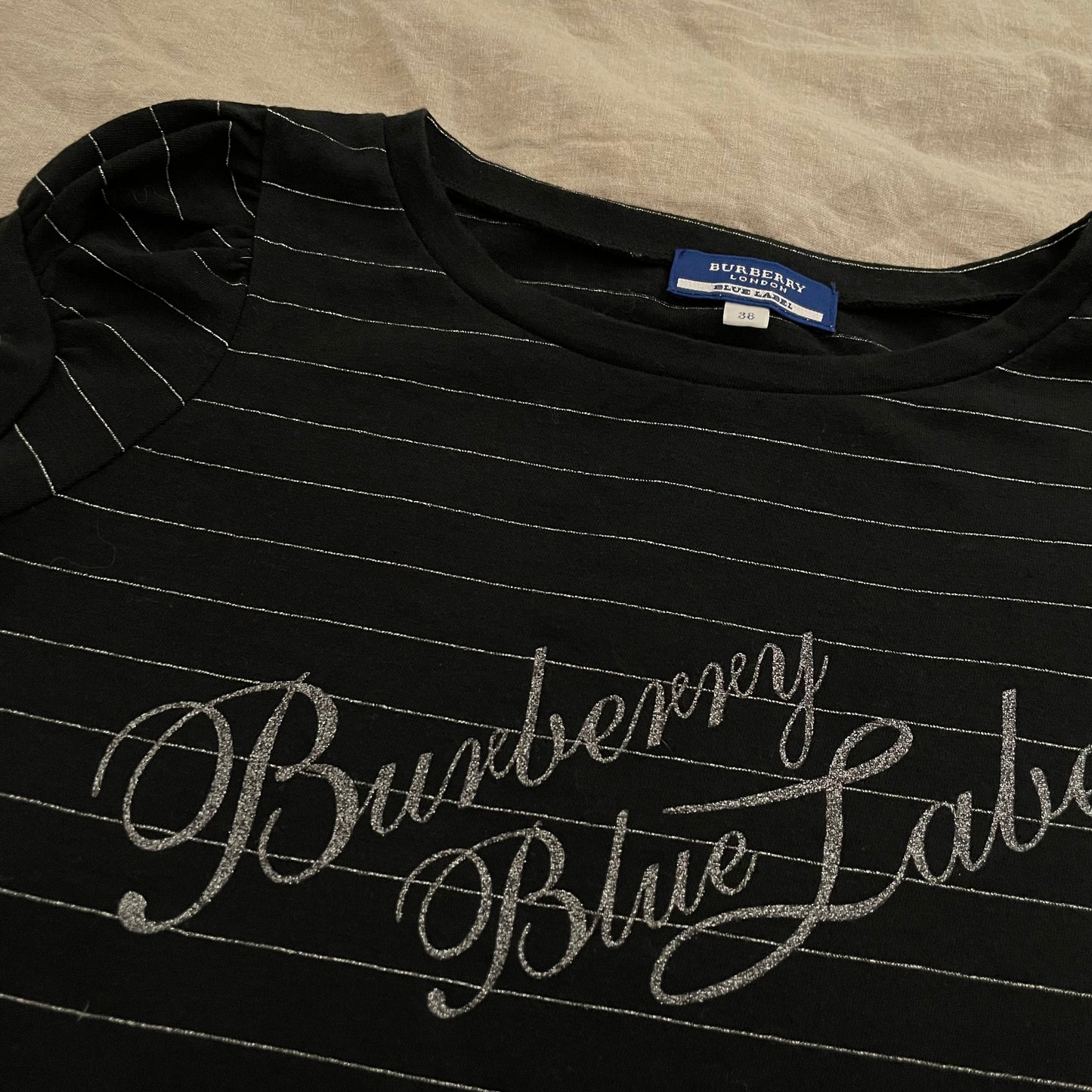 preppy coquete burberry blue label black puff sleeve top with silver stripes and italic text